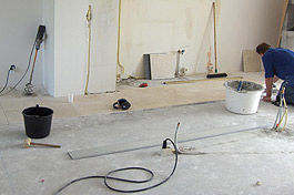 Het leidingwerk is van te voren al aangelegd zodat de monteur gelijk met de tegelvloer kan beginnen. Ook de muren waar de oude keuken stond zijn al verwijderd.