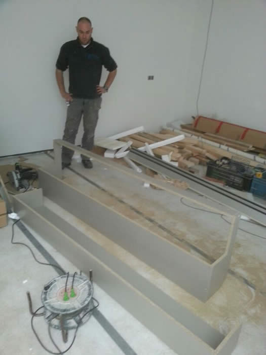De hoge kast die rondom de uitstulping in de muur heen gezet wordt moet in het werk op maat gemaakt worden.